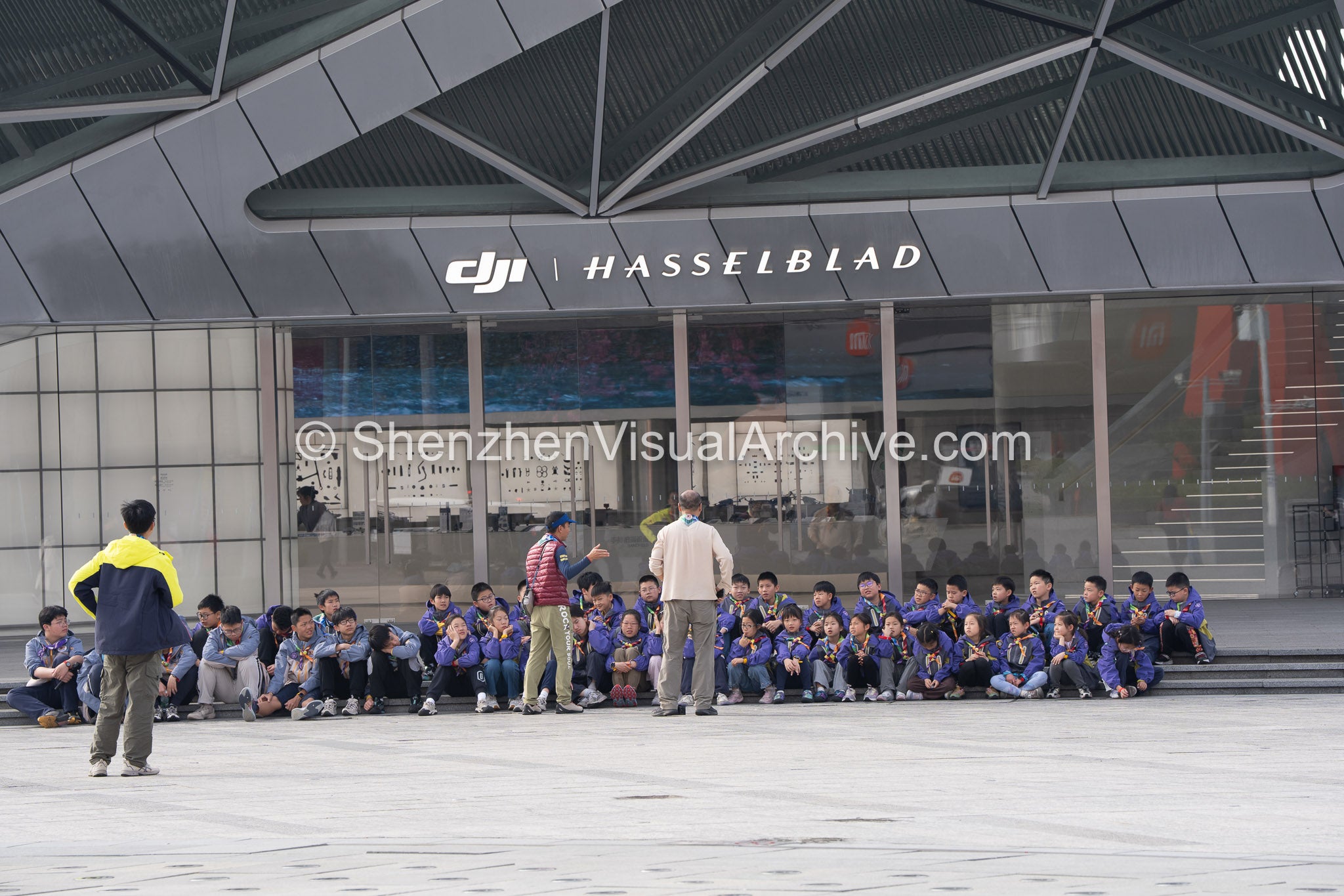 Students Group with Teachers at DJI Hasselblad Flagship Entrance OCT Harbour (SVA-26-0047)