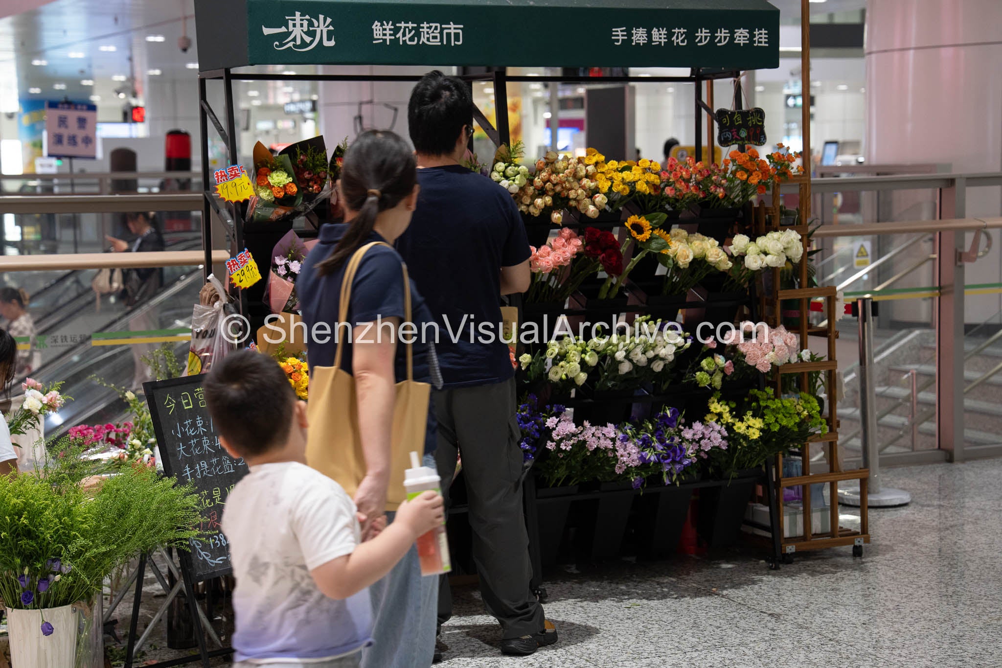 Commuter Shopping: Customers Browsing the Pop-up Florist at Gangxia North (SVA-26-0090)